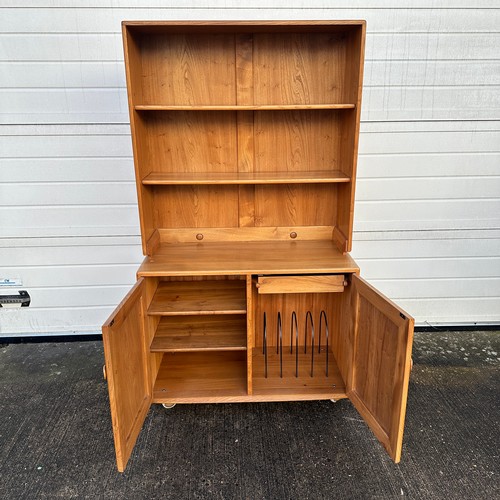 436 - Ercol – an Ercol Windsor blond elm bookcase cabinet with two adjustable shelves, over double cupboar... 