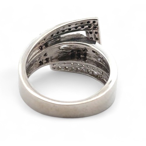 17 - A 9ct white gold ring set with black and white diamonds, size K. Diamonds 0.45ct approx. Weight 5.41... 