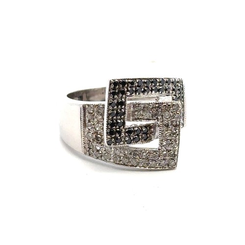 17 - A 9ct white gold ring set with black and white diamonds, size K. Diamonds 0.45ct approx. Weight 5.41... 