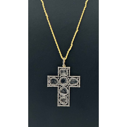 55 - An unusual silver-gilt cross set with slice-cut and rose-cut diamonds on a silver rope link chain. D... 