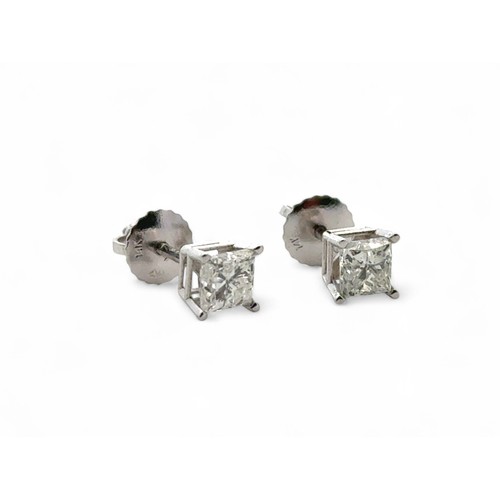 32 - A  pair of 14ct white gold princess cut diamond solitaire studs with screw back butterflies. Total d... 