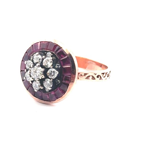 52 - A rose gold target style ring set with diamonds and rubies with patterned shoulders. Rubies 0.85ct a... 