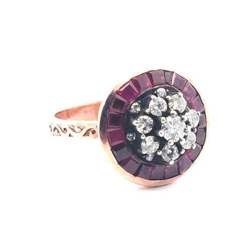 52 - A rose gold target style ring set with diamonds and rubies with patterned shoulders. Rubies 0.85ct a... 