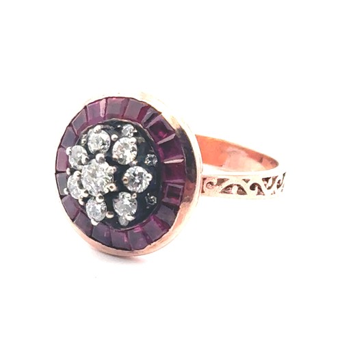 52 - A rose gold target style ring set with diamonds and rubies with patterned shoulders. Rubies 0.85ct a... 