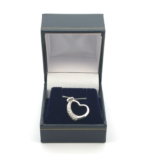 48 - A 9ct white gold diamond-set heart-shaped pendant on a silver chain. Gross weight 2.31g.