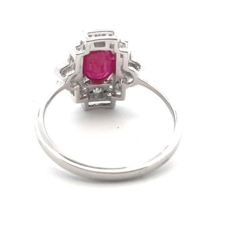 5 - An 18ct white gold Art Deco style ring set, size O/P.  Set with an oval ruby and with baguette and r... 