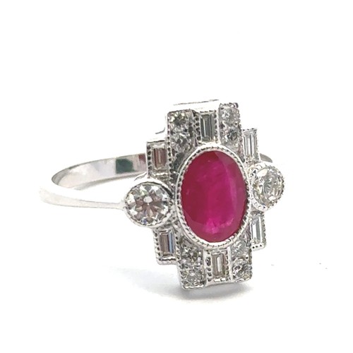 5 - An 18ct white gold Art Deco style ring set, size O/P.  Set with an oval ruby and with baguette and r... 