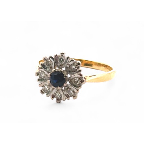 22 - A sapphire and diamond cluster style ring, stamped 18ct. Size N. 4.02g