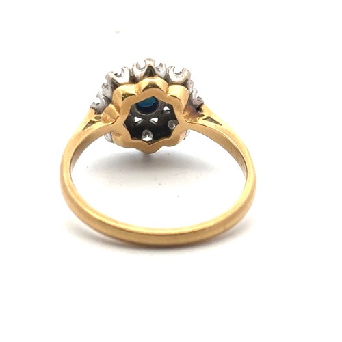 22 - A sapphire and diamond cluster style ring, stamped 18ct. Size N. 4.02g