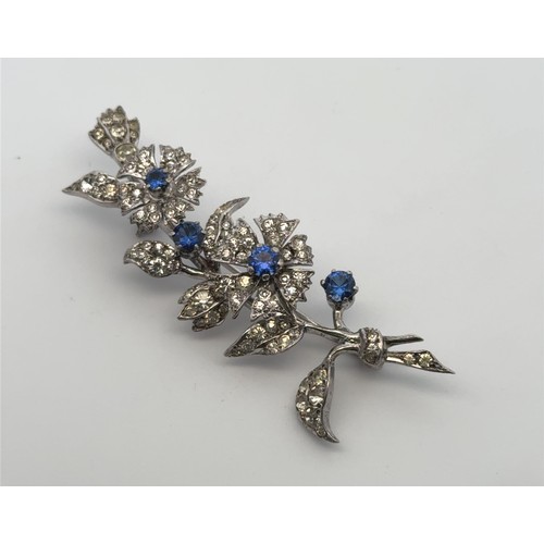 78 - A paste and synthetic sapphire flower brooch, stamped sterling silver. Length 6.5cm, weight 12.48g. ... 