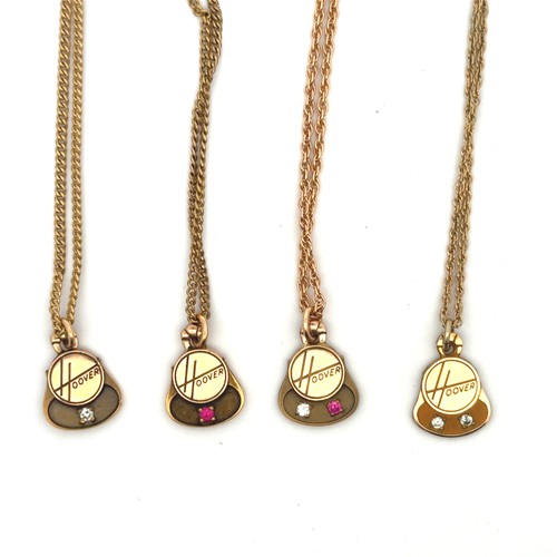 71 - A range of four yellow metal Hoover pattern pendants, each set two gemstones and stamped 'CTO 10K'.