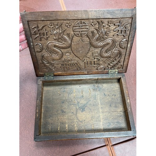 293 - Chinese carved wooden box with dragon design to lid, lid on hinges. Height 5cm, length 31cm, depth 2... 