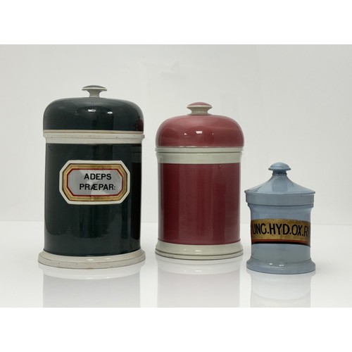 398 - Three Coloured Apothecary Jars: Largest, Dome topped Olive Green, raised ceramic gold foil label ADE... 