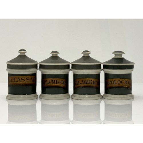 404 - Set of four Olive Green 19th Century ceramic apothecary jars with lids. All four have gilt labels, s... 