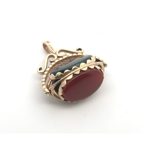 23 - A modern 9ct gold hardstone swivel spinner fob pendant, with bloodstone, carnelian and onyx. 7.52g. ... 