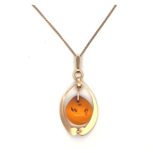 18 - A gold pendant necklace with amber drop, stamped as 583 gold. On a 18