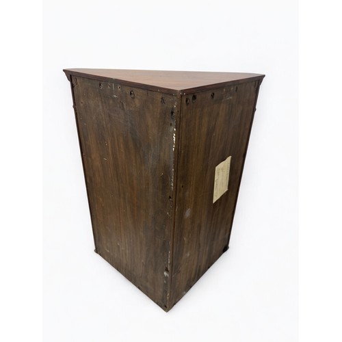 658 - A small walnut wood corner cabinet with key. Chemist's label attached to the back.  Dimensions appro... 