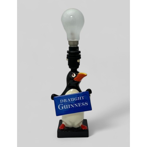 380 - Guinness original Carlton Ware Guinness table lamp, modelled as a standing penguin holding a 'Draugh... 