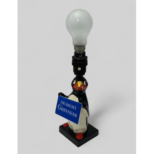 380 - Guinness original Carlton Ware Guinness table lamp, modelled as a standing penguin holding a 'Draugh... 