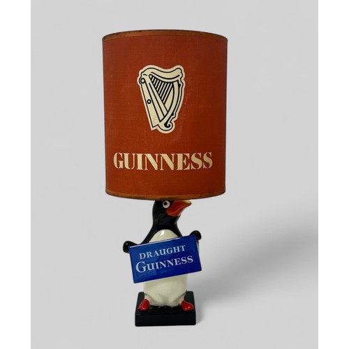 374 - Guinness, Carlton Ware Guinness Penguin Table Lamp modelled as a standing penguin holding a 'Draught... 