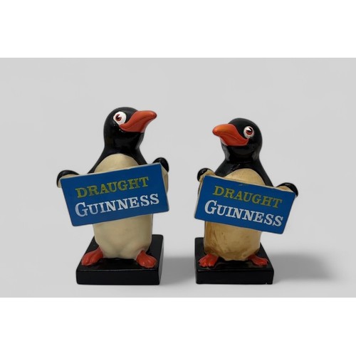 375 - Guinness, pair of Guinness Rubberoid Advertising Penguins. Both holding Draught Guinness signs 17cm ... 