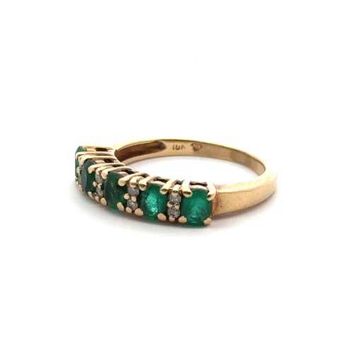 57 - A five stone emerald ring with diamond accents, stamped 18ct. Size K. Weight 3.36g