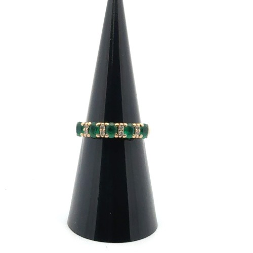 57 - A five stone emerald ring with diamond accents, stamped 18ct. Size K. Weight 3.36g