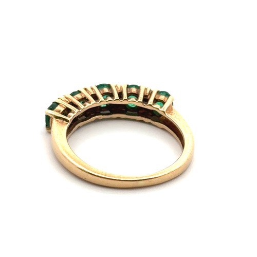 57 - A five stone emerald ring with diamond accents, stamped 18ct. Size K. Weight 3.36g