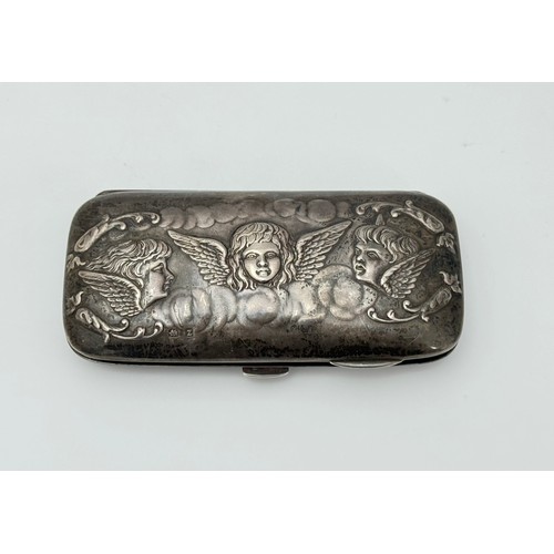 161 - A late Victorian art nouveau silver ladies purse with cherub decoration and green interior lining. L... 