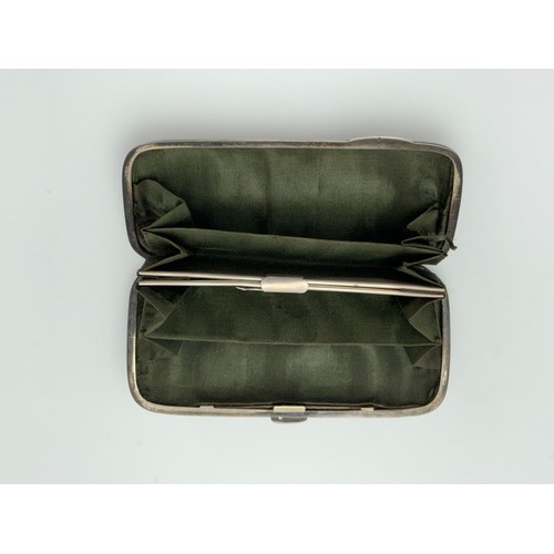 161 - A late Victorian art nouveau silver ladies purse with cherub decoration and green interior lining. L... 