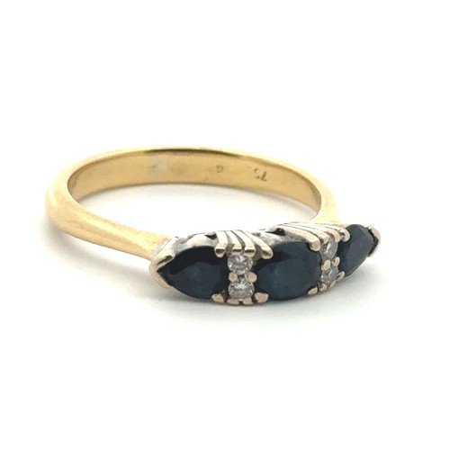 29 - A sapphire ring in 18ct gold with diamond accents, size P.