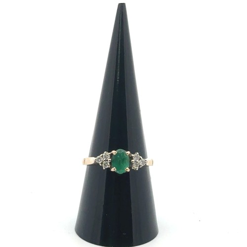 33 - An emerald and diamond ring set in 9ct gold, sponsor S & Co, size P. Weight 2.97g.