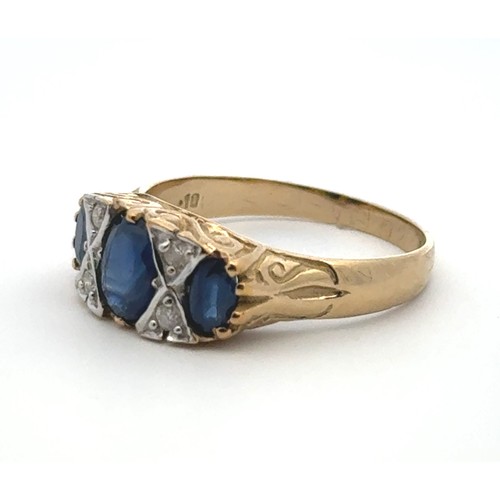 30 - A sapphire and diamond ring set in 9ct yellow gold with a scroll mount. Size Q/R.