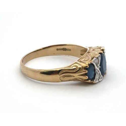 30 - A sapphire and diamond ring set in 9ct yellow gold with a scroll mount. Size Q/R.