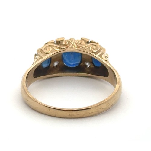 30 - A sapphire and diamond ring set in 9ct yellow gold with a scroll mount. Size Q/R.