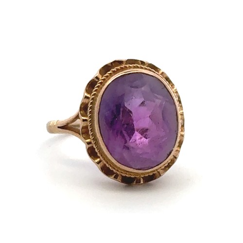 37 - An oval amethyst ring set in 9ct gold, size I. Some wear to amethyst facets. 2.73g