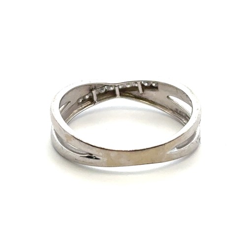 31 - A diamond and 9ct white gold ring with a split crossover shank, size R .