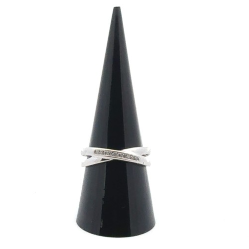 31 - A diamond and 9ct white gold ring with a split crossover shank, size R .