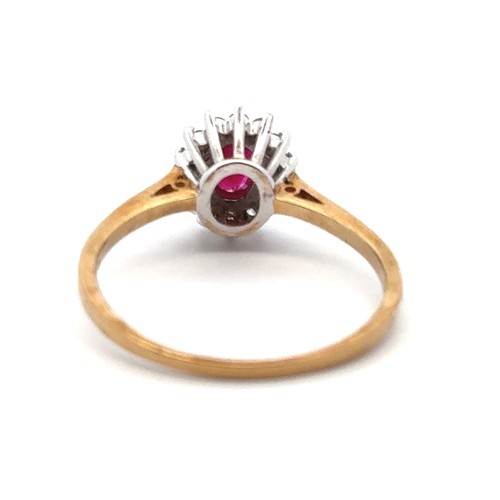 7 - An oval ruby and diamond cluster ring in 9ct gold, size R. 2.34g