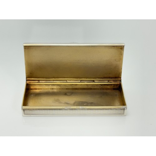 163 - A French silver pill box with a stone set thumb piece and gilt interior. Dimensions 80mm x 35mm. 47.... 