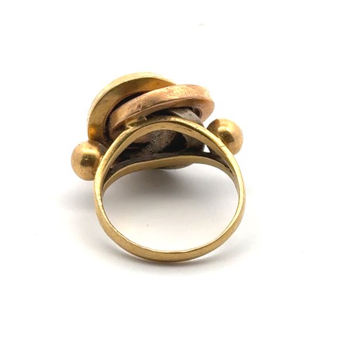 42 - A gold tri-coloured ring designed as three interlocking circles, size M/N, unmarked but tested as ap... 