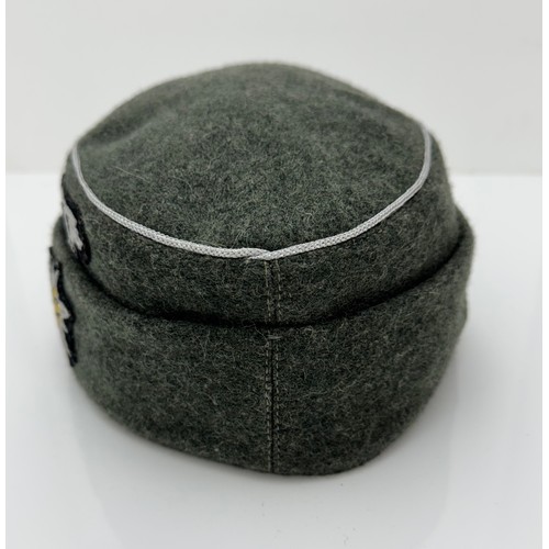 63 - Two reproduction WWII German caps. A reproduction  'SS' M43 field cap with good quality insignia, si... 