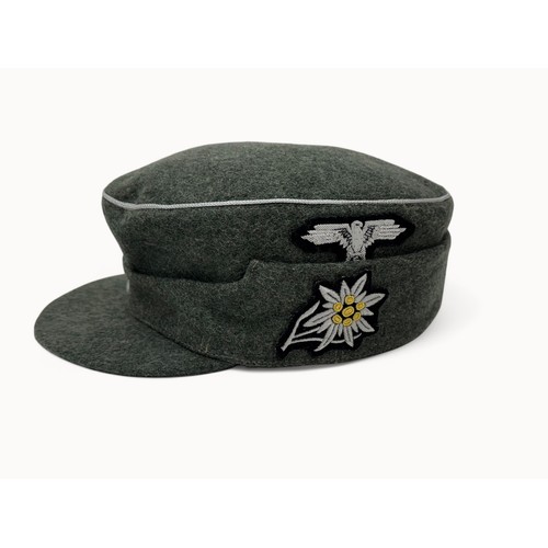 63 - Two reproduction WWII German caps. A reproduction  'SS' M43 field cap with good quality insignia, si... 