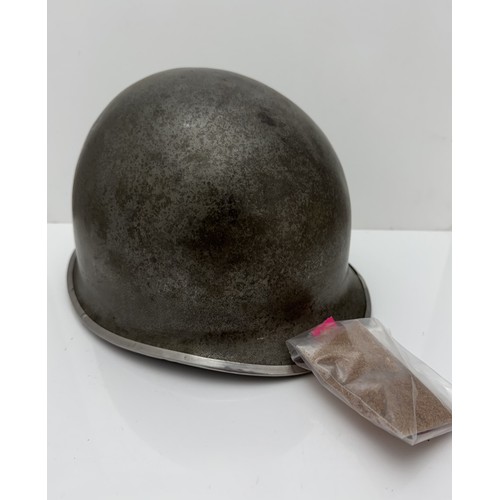 112 - A WWII US military McCord made steel combat helmet shell, fixed bales and front seam. Marked 
?077 0... 