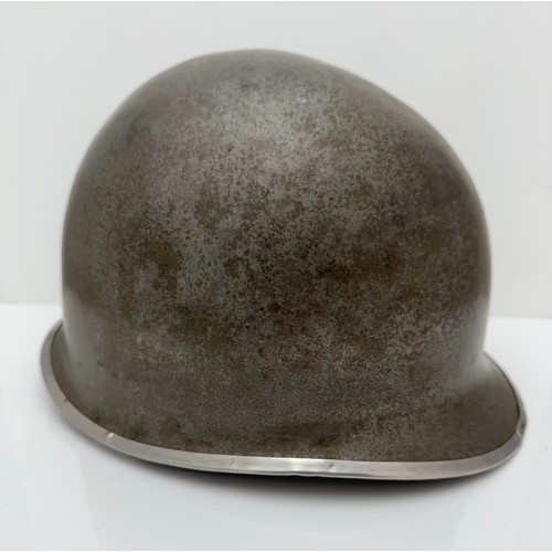 112 - A WWII US military McCord made steel combat helmet shell, fixed bales and front seam. Marked 
?077 0... 