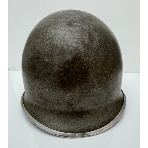 112 - A WWII US military McCord made steel combat helmet shell, fixed bales and front seam. Marked 
?077 0... 