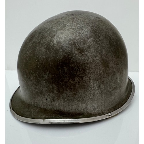 112 - A WWII US military McCord made steel combat helmet shell, fixed bales and front seam. Marked 
?077 0... 