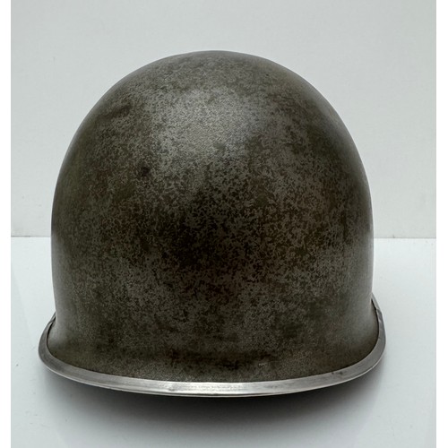 112 - A WWII US military McCord made steel combat helmet shell, fixed bales and front seam. Marked 
?077 0... 