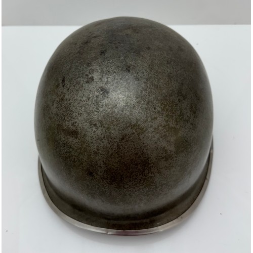 112 - A WWII US military McCord made steel combat helmet shell, fixed bales and front seam. Marked 
?077 0... 