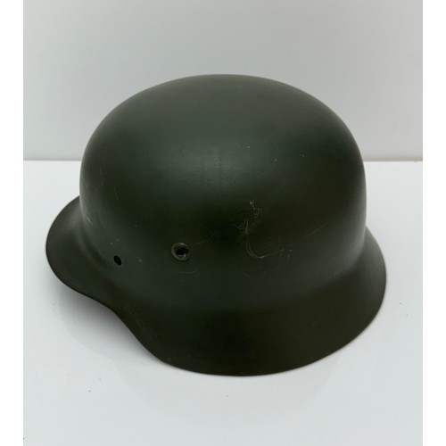 64 - WWII German M35 steel army combat helmet shell.  Marked ET64 to side inner rim and 3001 to back inne... 